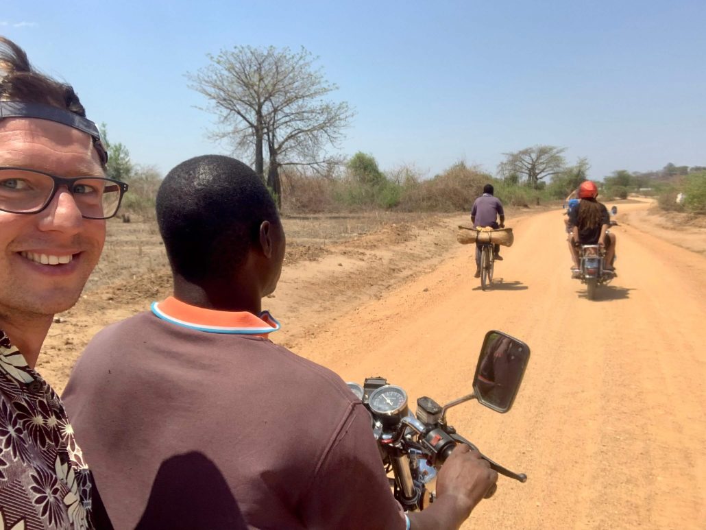 Dilo using a local motorbike taxi